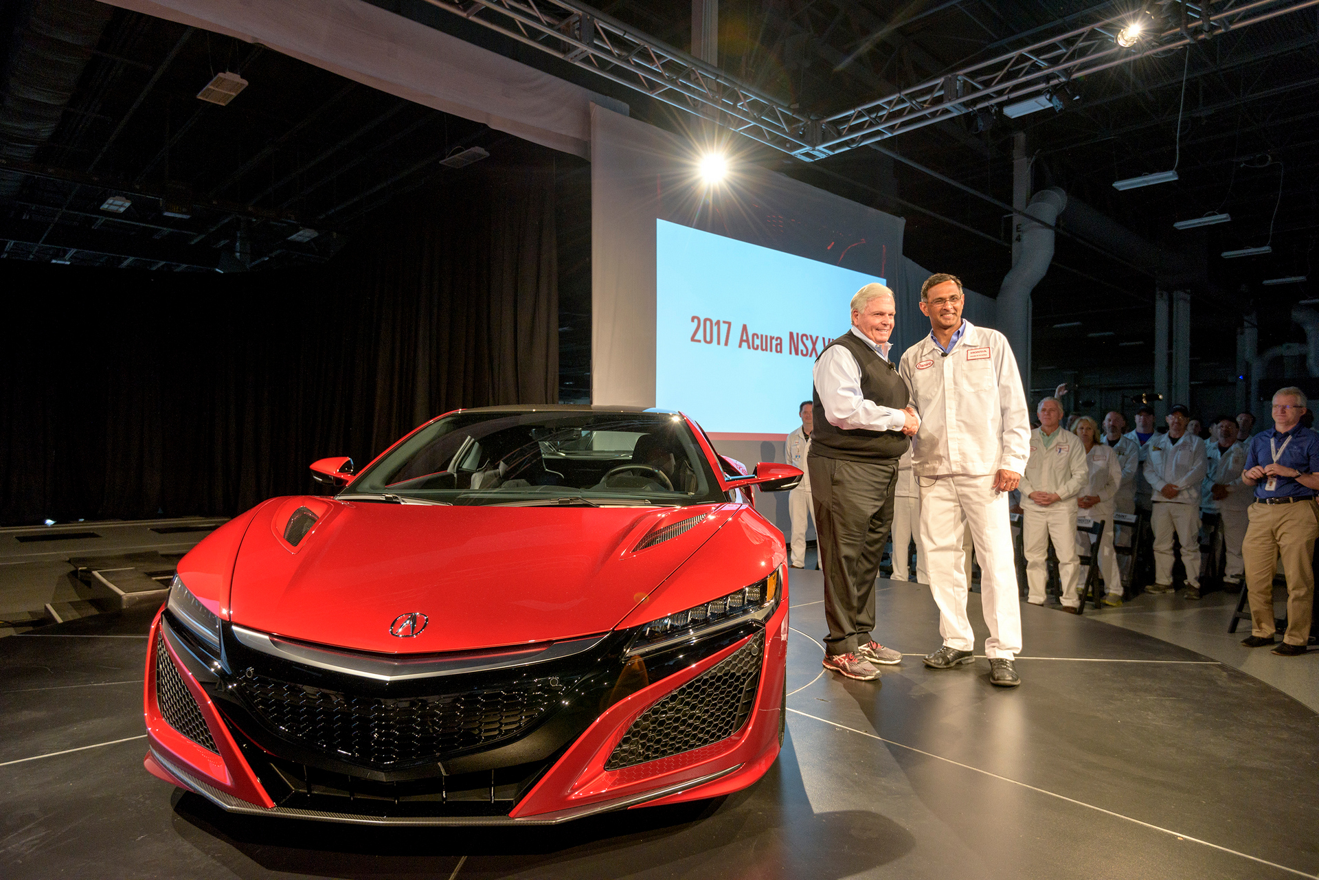 From left, Rick Hendrick, owner of Hendrick Motorsports and Hendrick Automotive Group, takes delivery of 2017 Acura NSX, VIN 001, from Acura NSX Engineering Large Project Leader Clement D'Souza © Honda Motor Co., Ltd.
